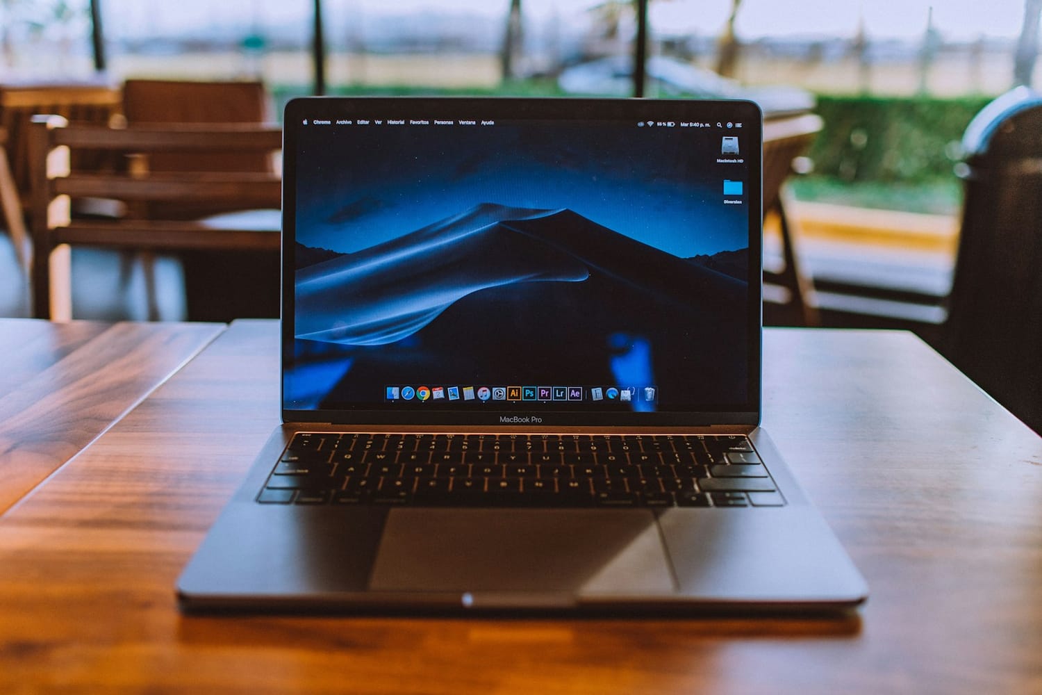 A laptop on a wooden café table