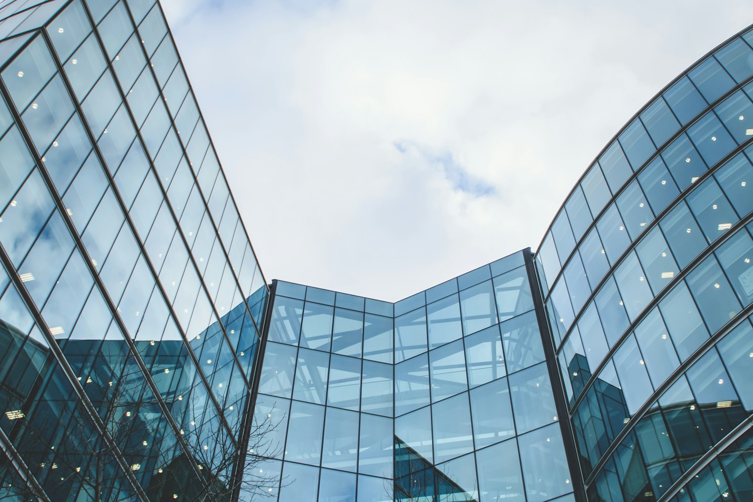Curved glass facades of a modern office building against the sky