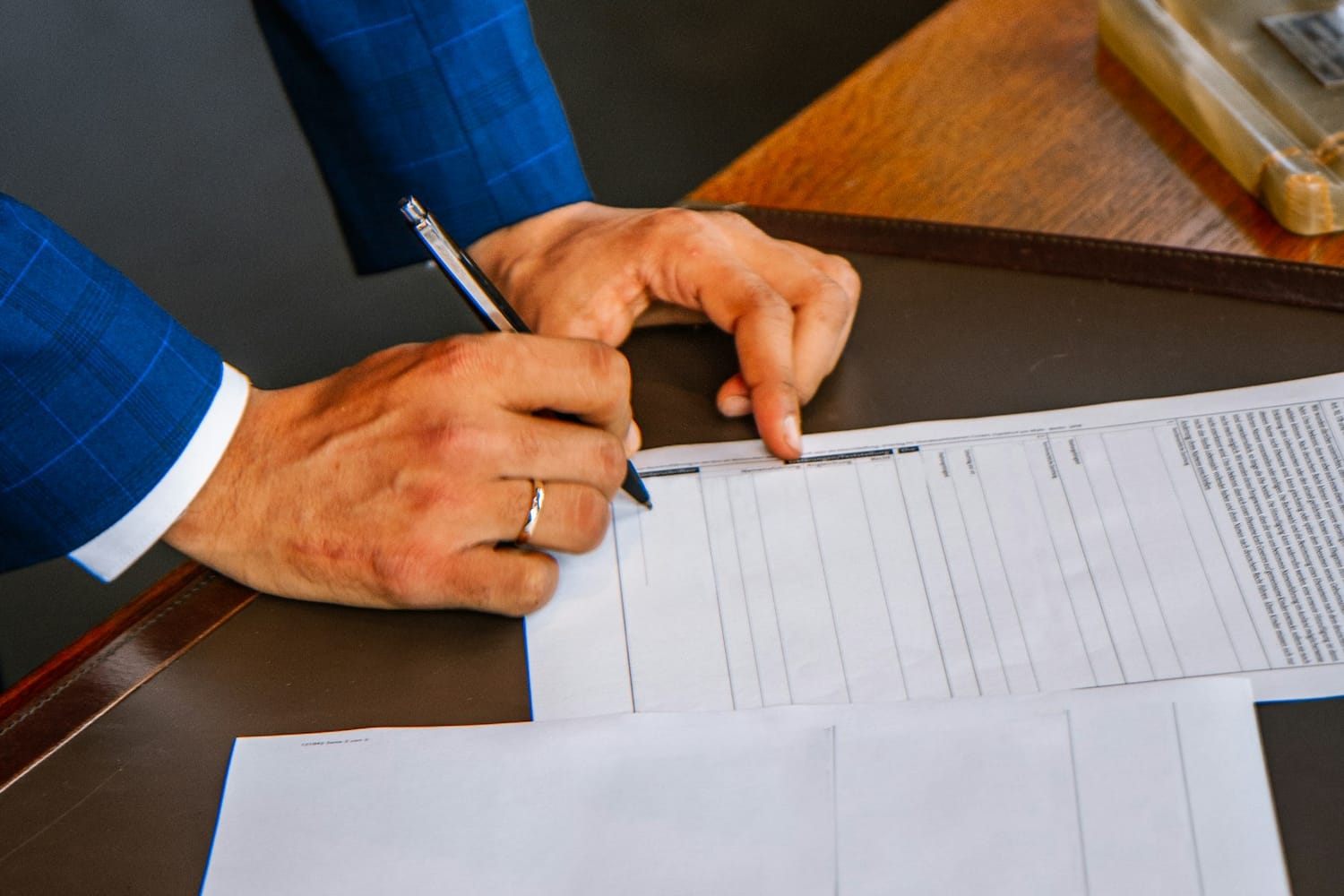 A person filling in a printed form with a pen